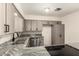 Stunning kitchen showcasing granite countertops, a stainless steel sink, and updated appliances at 126 N 58Th St, Mesa, AZ 85205