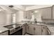 Charming kitchen featuring granite countertops, updated appliances, and wood cabinetry at 126 N 58Th St, Mesa, AZ 85205