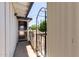 Side entrance featuring a wrought iron trellis, screen door, and painted siding at 126 N 58Th St, Mesa, AZ 85205