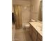 Bathroom features a shower with gold curtain, toilet, sink, and vanity with marble counter at 12955 E Sahuaro Dr, Scottsdale, AZ 85259