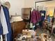 Bedroom with clothing rack, mirror, lamp, sewing machine, and some clutter at 12955 E Sahuaro Dr, Scottsdale, AZ 85259