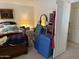 Bedroom featuring a large bed, nightstands, a painting, and some storage bins at 12955 E Sahuaro Dr, Scottsdale, AZ 85259