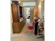 Hallway with dresser, china cabinet, furniture, clothing rack, and stacked moving boxes at 12955 E Sahuaro Dr, Scottsdale, AZ 85259
