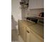 Functional laundry room with washer, dryer, overhead shelves, and doorway at 12955 E Sahuaro Dr, Scottsdale, AZ 85259