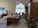 Bright living room featuring vaulted ceilings and a large arched window allowing natural light at 12955 E Sahuaro Dr, Scottsdale, AZ 85259