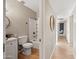 Hallway view of a bathroom with a tub and shower, and white vanity next to the hallway at 1307 E Broadmor Dr, Tempe, AZ 85282