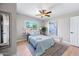 Bedroom featuring a queen bed, neutral walls, natural lighting, and a ceiling fan at 1307 E Broadmor Dr, Tempe, AZ 85282