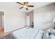 Bright bedroom features a ceiling fan, wood floors, and a large bed with soft blue bedding at 1307 E Broadmor Dr, Tempe, AZ 85282