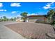 Tan brick home with desert landscaping and a covered carport at 1307 E Broadmor Dr, Tempe, AZ 85282
