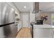 Open kitchen with white cabinetry and stainless steel appliances at 1307 E Broadmor Dr, Tempe, AZ 85282