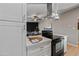 Modern kitchen featuring white cabinets, quartz countertops, and stainless steel appliances at 1307 E Broadmor Dr, Tempe, AZ 85282