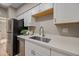 Kitchen with stainless steel appliances, white cabinets, quartz counters, and a modern faucet at 1307 E Broadmor Dr, Tempe, AZ 85282