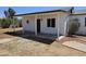 Charming home exterior with a covered porch, enhancing curb appeal and offering a welcoming entrance at 15445 N Verde St, Surprise, AZ 85378