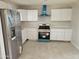 Modern kitchen featuring new stainless steel appliances and white cabinetry at 15445 N Verde St, Surprise, AZ 85378