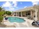 Charming backyard with a kidney-shaped pool, covered patio, and ample space for outdoor activities at 15501 W Camino Real Way, Surprise, AZ 85374
