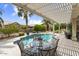 Inviting backyard pool with covered patio seating, perfect for entertaining or relaxing by the water at 15501 W Camino Real Way, Surprise, AZ 85374