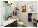 A cozy bathroom features a vessel sink, dark wood cabinets, and calming decor at 15501 W Camino Real Way, Surprise, AZ 85374