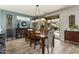 Inviting dining room featuring stylish decor, wood floors, and sliding glass doors to the outdoor pool area at 15501 W Camino Real Way, Surprise, AZ 85374