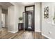 Bright foyer with wood flooring, a stylish front door, and tasteful decor accents at 15501 W Camino Real Way, Surprise, AZ 85374