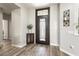 Welcoming foyer featuring wood-look floors, a modern front door, and neutral wall colors at 15501 W Camino Real Way, Surprise, AZ 85374