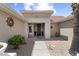Inviting front entry with a covered porch, desert landscaping, and an attractive metal front door at 15501 W Camino Real Way, Surprise, AZ 85374