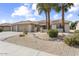 Beautiful single-story home with a tile roof, desert landscaping, and a spacious three-car garage at 15501 W Camino Real Way, Surprise, AZ 85374