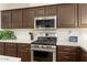 Modern kitchen boasts stainless steel appliances, white subway tile backsplash, and ample cabinet space at 15501 W Camino Real Way, Surprise, AZ 85374