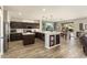 Bright kitchen featuring a central island, stainless appliances, and an open layout to the dining area at 15501 W Camino Real Way, Surprise, AZ 85374