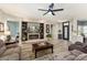 Inviting living room featuring wood flooring, a TV, and a view of the front entrance at 15501 W Camino Real Way, Surprise, AZ 85374