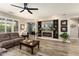 Comfortable living room with a built-in entertainment center, wood floors, and neutral paint at 15501 W Camino Real Way, Surprise, AZ 85374