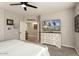 Spacious main bedroom features a decorative dresser and an open doorway, leading to other rooms at 15501 W Camino Real Way, Surprise, AZ 85374