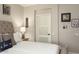A cozy bedroom features a tufted headboard, accent pillows, and calming wall decor at 15501 W Camino Real Way, Surprise, AZ 85374