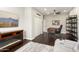 The home office has hardwood floors, a ceiling fan, a desk, and a electric fireplace at 15501 W Camino Real Way, Surprise, AZ 85374