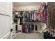 This spacious walk-in closet features organized shelving, hanging rods, and carpeted floors at 15501 W Camino Real Way, Surprise, AZ 85374
