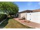 Private backyard with a patio, lounge chair, and well-maintained lawn, perfect for outdoor enjoyment at 15614 N Lakeforest Dr, Sun City, AZ 85351