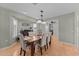 Formal dining room with wood floors, stylish table set for six, and plantation shutters at 15614 N Lakeforest Dr, Sun City, AZ 85351