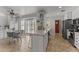 Bright kitchen with an island, stylish tile floors, modern appliances, and lots of natural light at 15614 N Lakeforest Dr, Sun City, AZ 85351