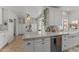 Modern kitchen featuring white cabinets, stainless steel appliances, granite countertops, and ample storage space at 15614 N Lakeforest Dr, Sun City, AZ 85351