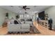 Spacious living room with hardwood floors, sectional sofa, and abundant natural light at 15614 N Lakeforest Dr, Sun City, AZ 85351