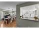 Open floor plan displaying dining room, kitchen, and living room with hardwood floors and modern design at 15614 N Lakeforest Dr, Sun City, AZ 85351