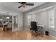 Well-lit office space with hard wood floors, desk, and large window at 15614 N Lakeforest Dr, Sun City, AZ 85351