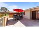 Cozy backyard patio with a red umbrella, grill, and outdoor seating, ideal for entertaining guests at 15614 N Lakeforest Dr, Sun City, AZ 85351