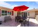 Outdoor patio seating area with a large umbrella, perfect for enjoying sunny days with comfortable furniture at 15614 N Lakeforest Dr, Sun City, AZ 85351