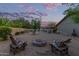 Inviting backyard space with a cozy fire pit area, comfortable seating, and open patio views at 15849 N 46Th Pl, Phoenix, AZ 85032