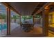 Covered patio with a dining area, string lights, and a peek at the refreshing pool at 15849 N 46Th Pl, Phoenix, AZ 85032