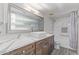 This bathroom features a long vanity, a large framed mirror and a shower/tub combo at 15849 N 46Th Pl, Phoenix, AZ 85032