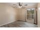 Neutral bedroom with light tan walls, gray wood-look floors, and a ceiling fan at 15849 N 46Th Pl, Phoenix, AZ 85032