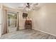 This is a small bedroom with a desk, TV, ceiling fan and exterior access at 15849 N 46Th Pl, Phoenix, AZ 85032