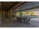 Spacious covered patio with a dining table, chairs, a grill, and views of the sparkling pool at 15849 N 46Th Pl, Phoenix, AZ 85032