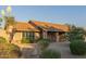 Inviting home with desert landscaping, mature bushes, and charming brick accents at 15849 N 46Th Pl, Phoenix, AZ 85032